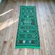 Handwoven green Moroccan hallway rug with geometric patterns.