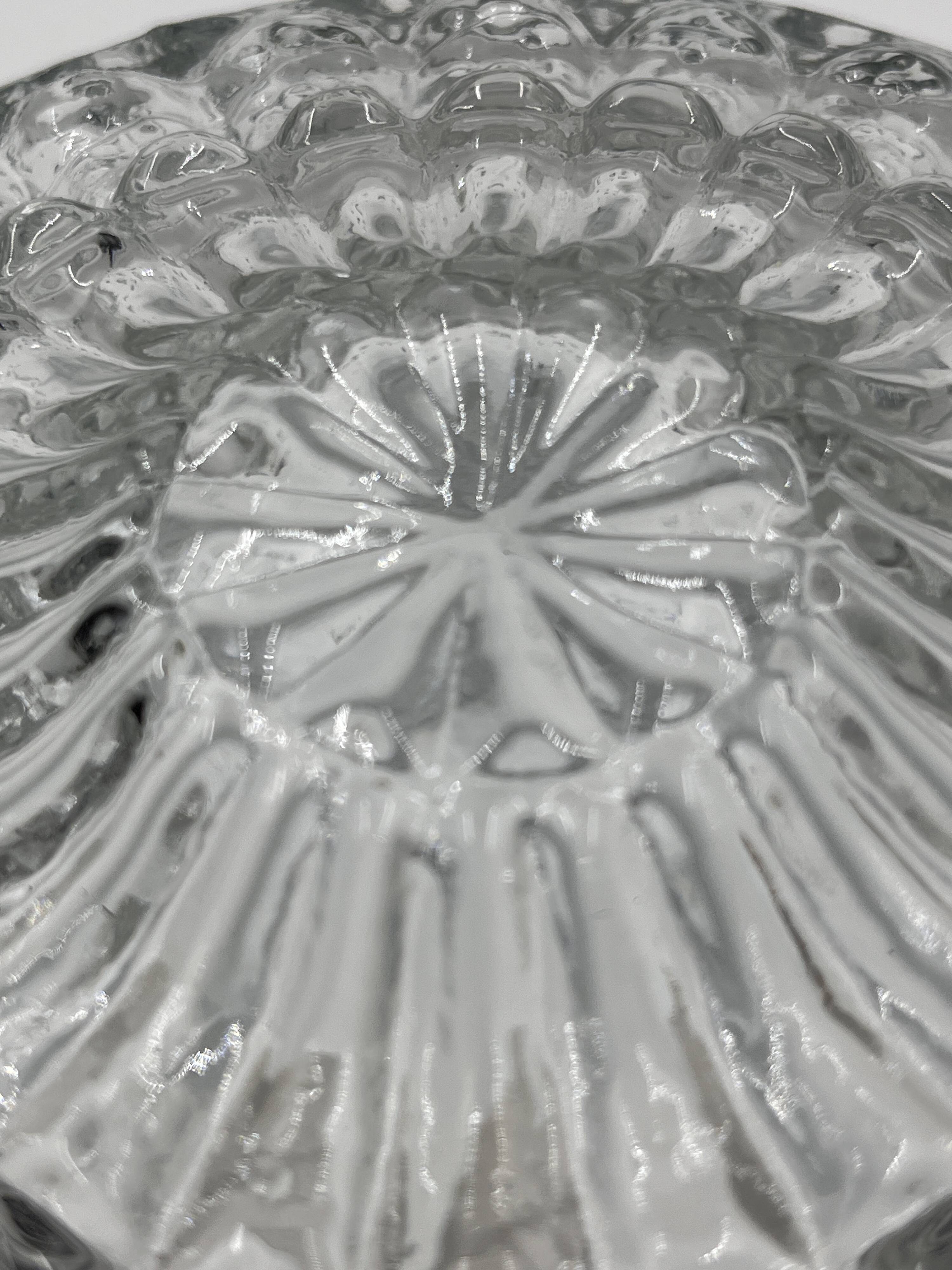 Molded glass ceiling light with spinning top relief