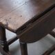 Antique English drop-leaf joint stool made of oak from the 18th century