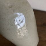 Stoneware bottle tilted at an angle, early 20th century