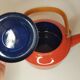 Orange and bamboo enamelled metal teapot in the 1970s