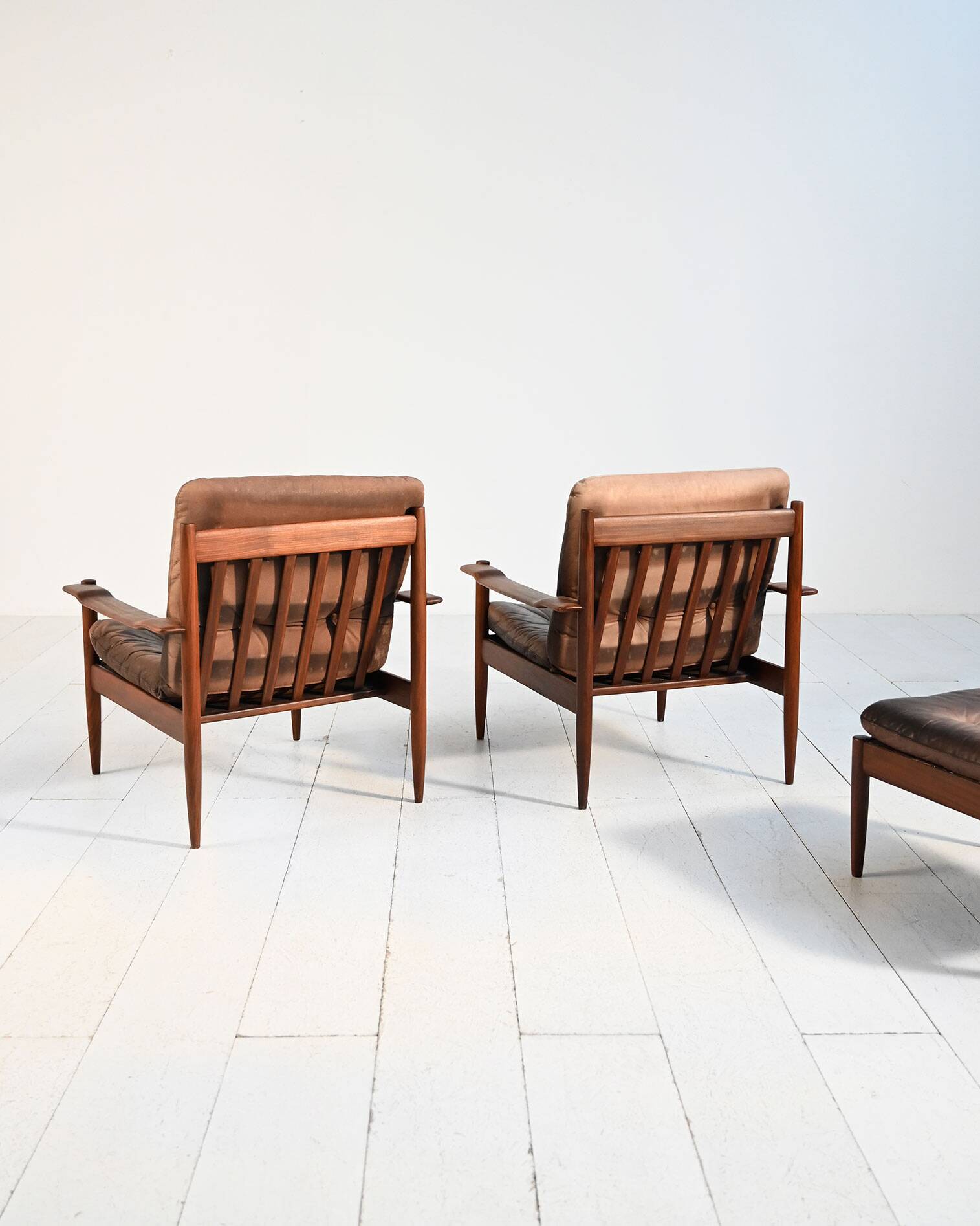 Scandinavian teak and leather lounge set with two armchairs and ottoman