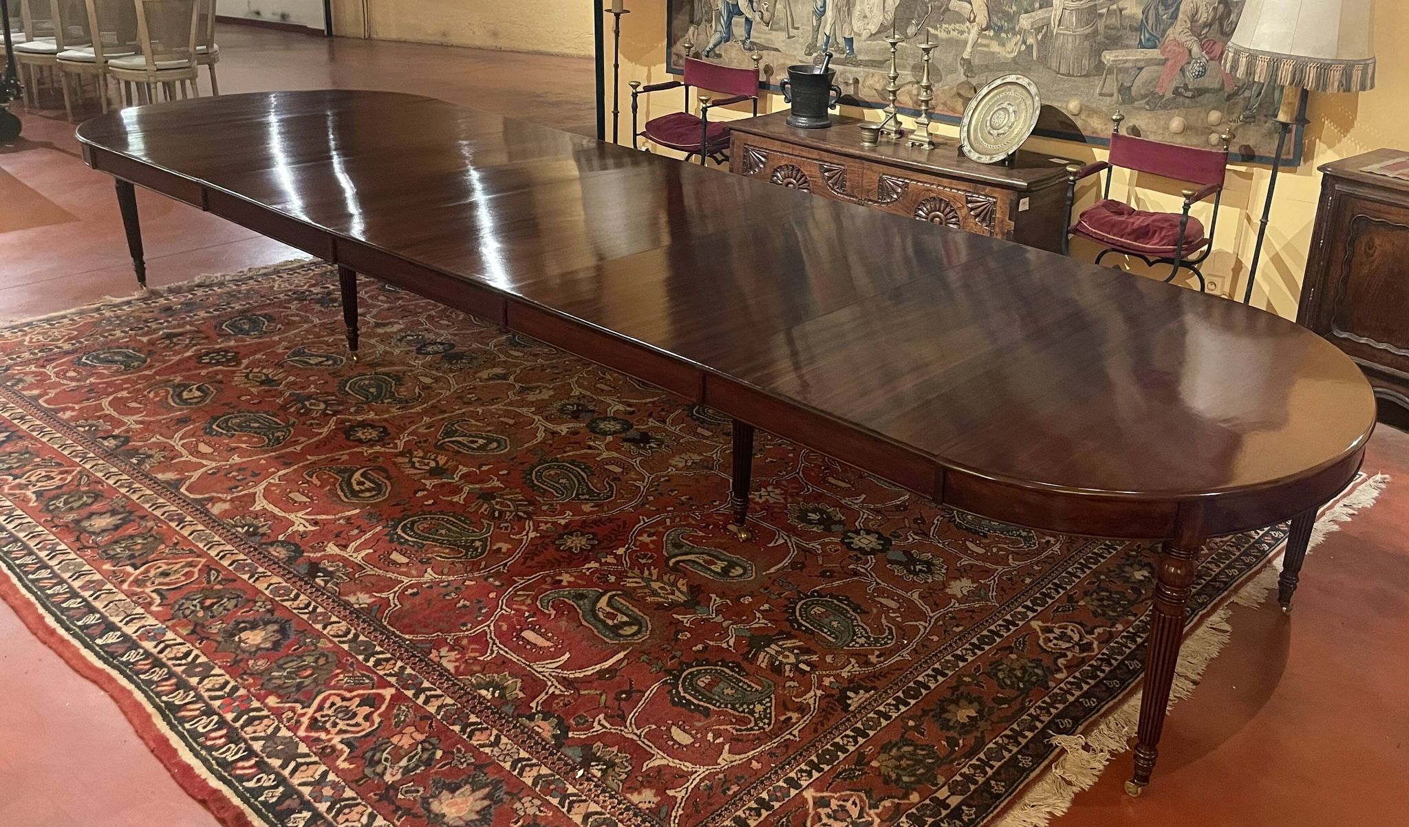 Extensible dining table from the Louis XVI period in mahogany with a banded top.
