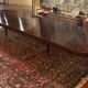 Extensible dining table from the Louis XVI period in mahogany with a banded top.