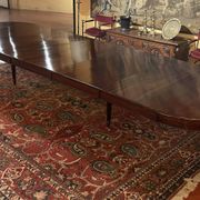 Extensible dining table from the Louis XVI period in mahogany with a banded top.