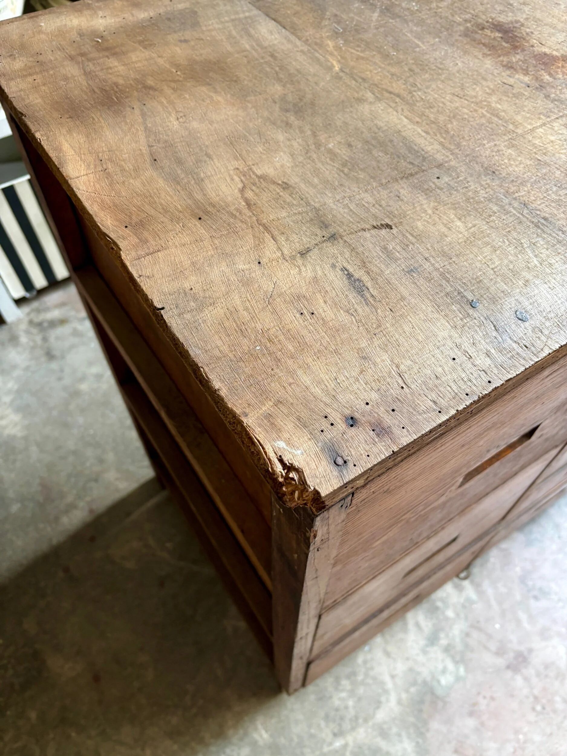 Craftsman's cabinet with 16 drawers in dark wood.