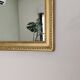 Antique mirror with a gilded frame and beaded border.