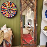 Wooden mirror mounted on old door