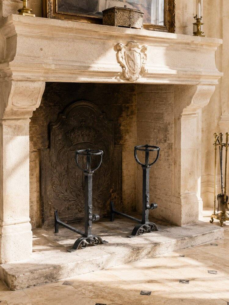 Pair of cast iron fire dogs from a château