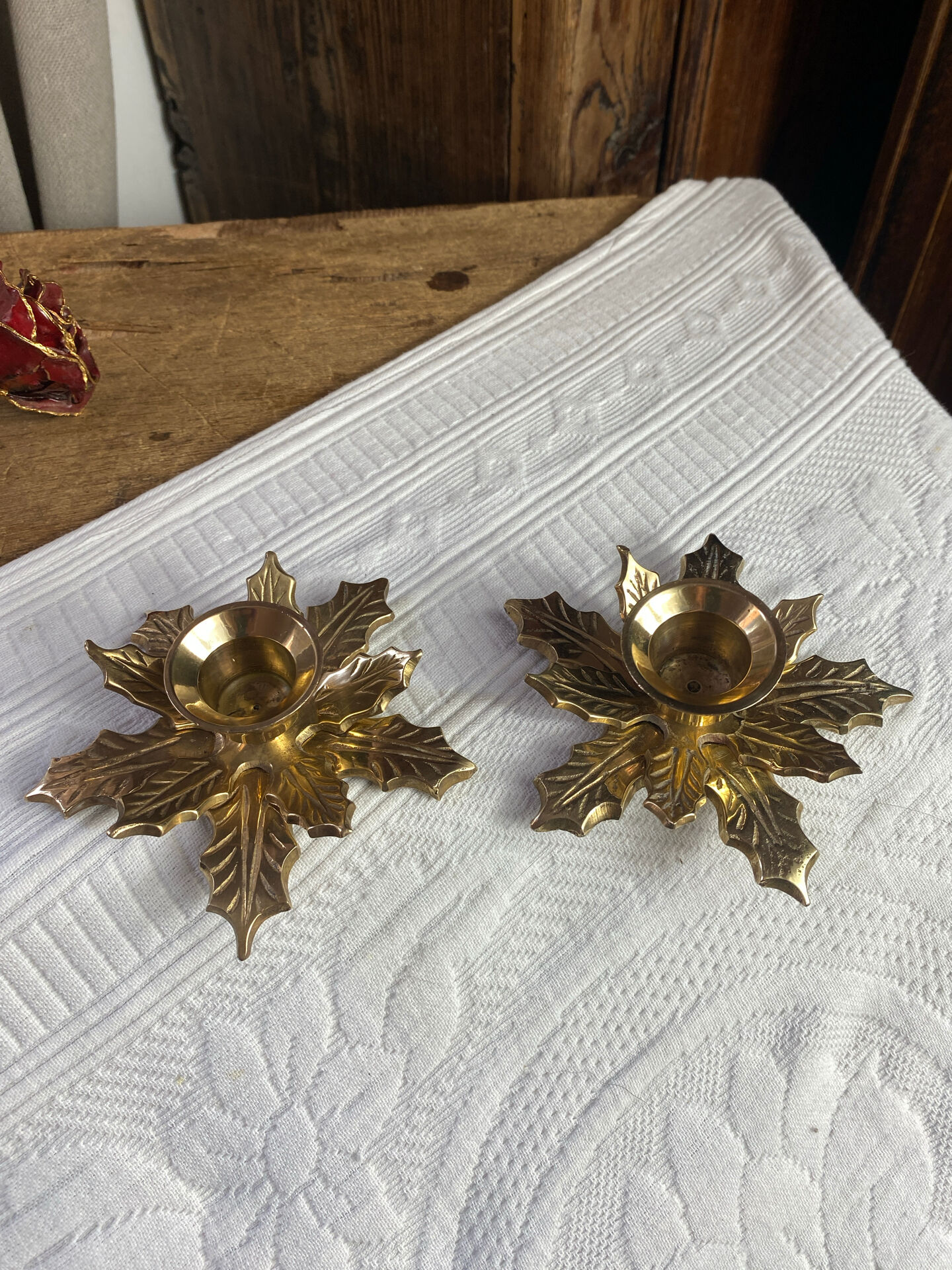 Pair of candlesticks, holly leaves, in brass