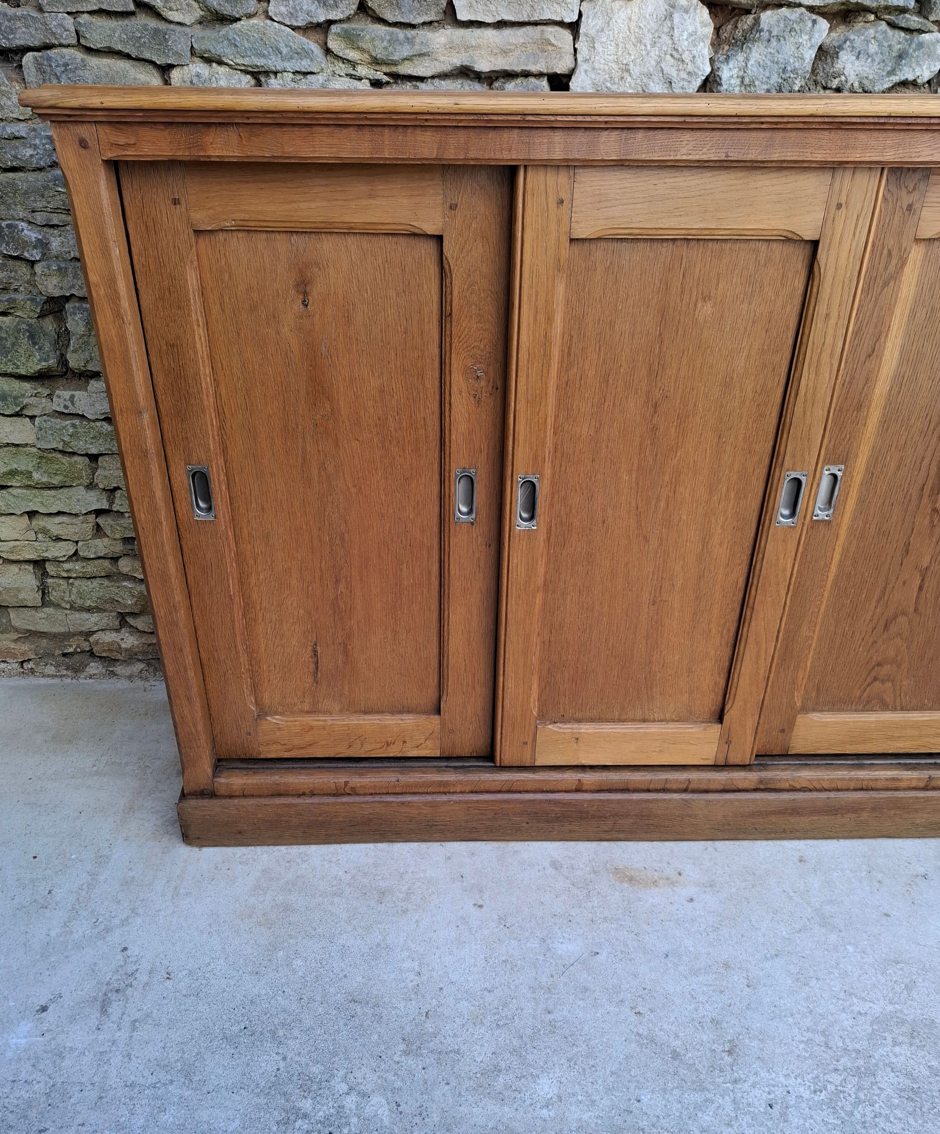 Oak workshop furniture with sliding doors.