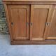 Oak workshop furniture with sliding doors.