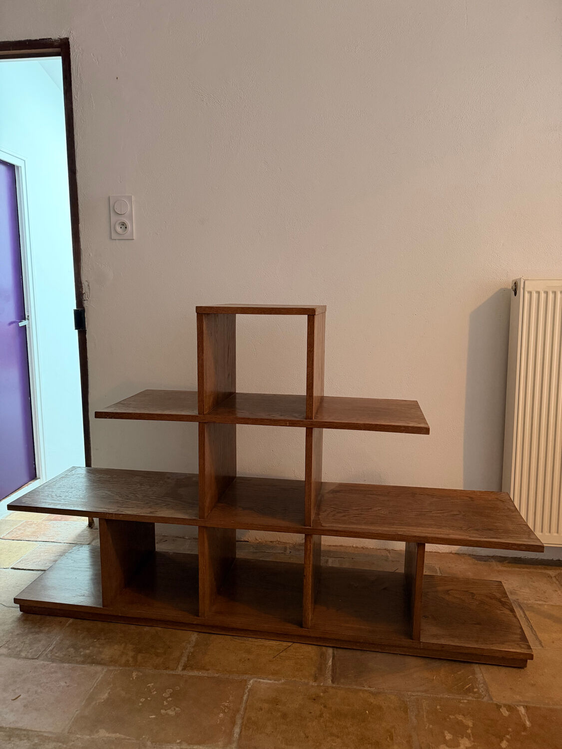 Low wooden shelf in 1960s brutalist style.