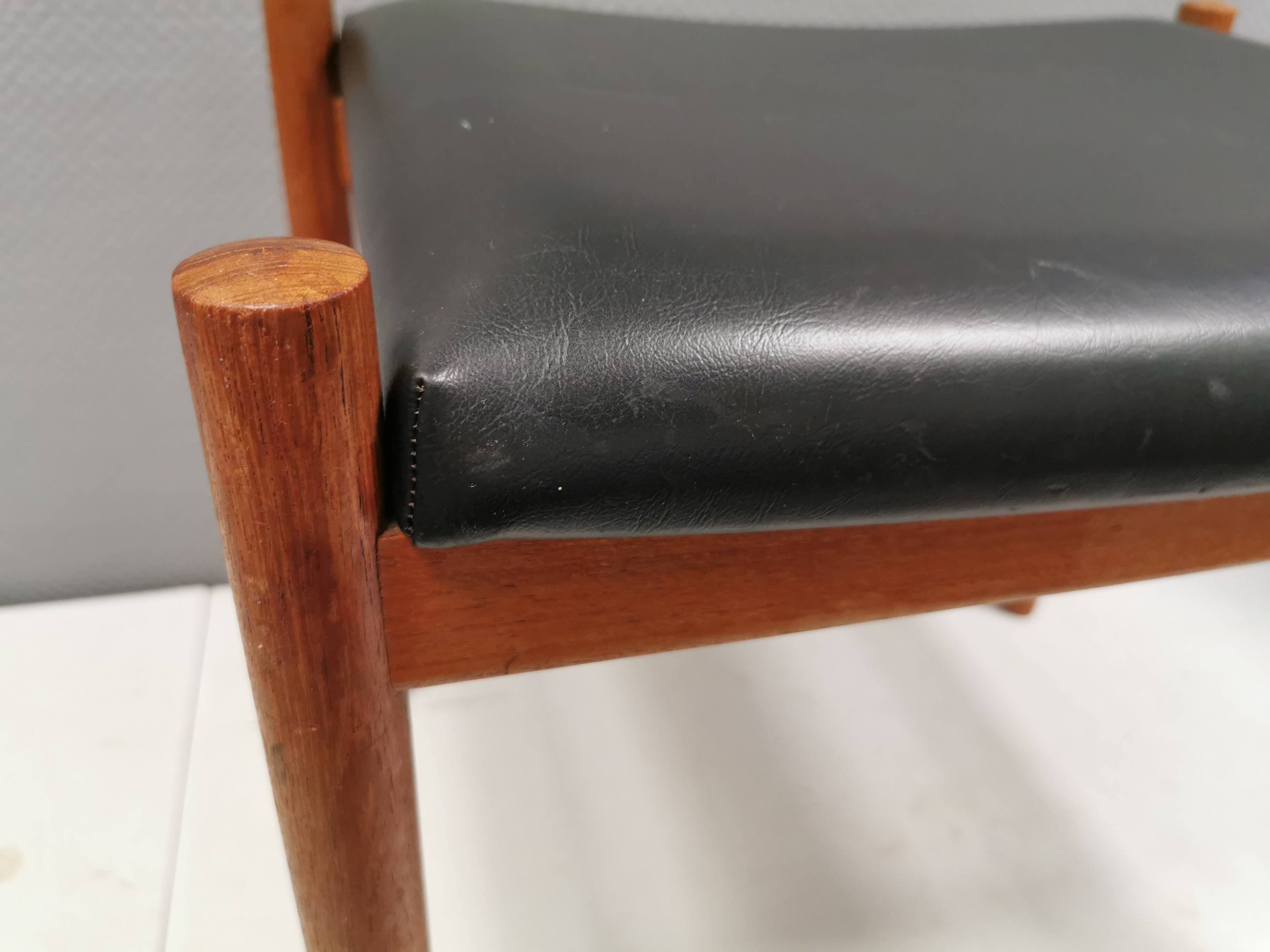 Danish designed footstool in teak wood and black skai “imitation leather”