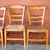 Set of 5 mismatched straw chairs.