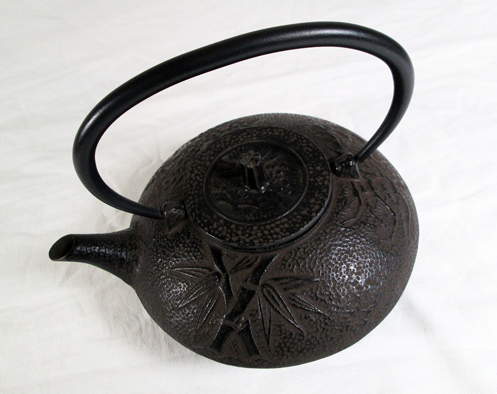 Antique cast iron teapot decorated