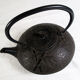 Antique cast iron teapot decorated