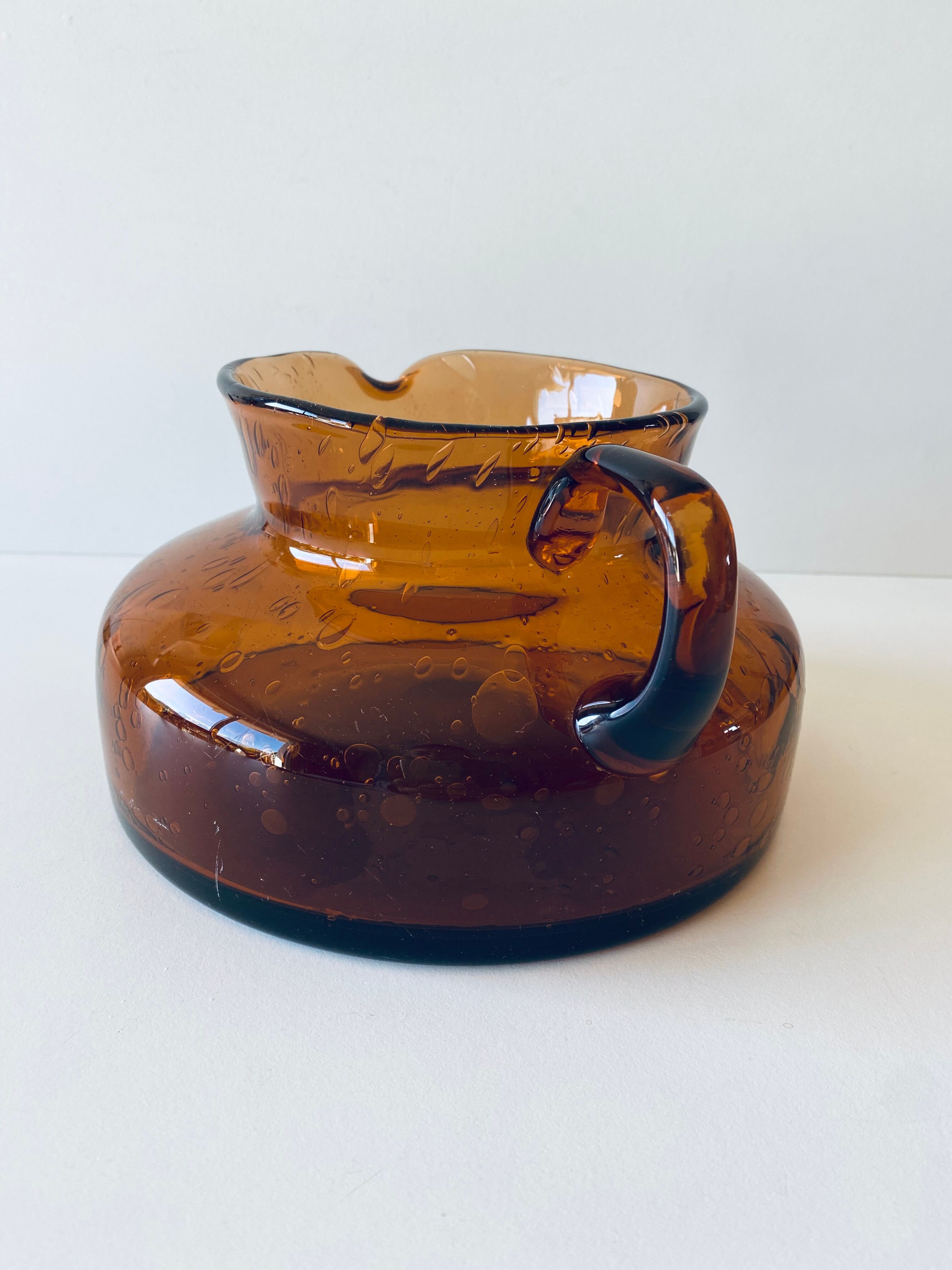 Decanter made of blown and bubbled amber glass