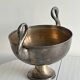 Large champagne bucket with patinated metal swan handles.