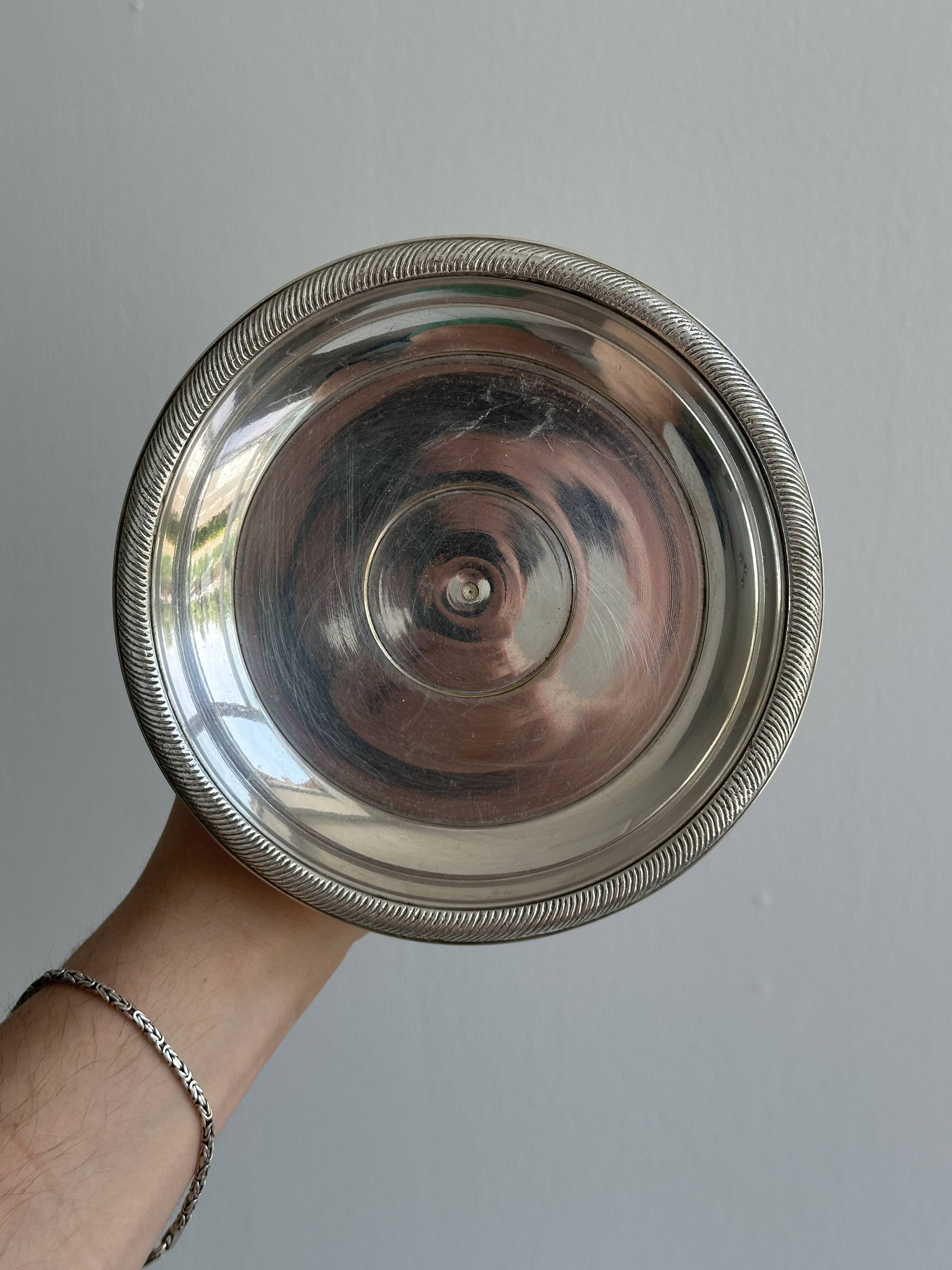Silver-plated metal stand.