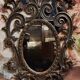 Antique Louis XV style mirror, richly carved with decorations of scrolls, shells, and foliage.