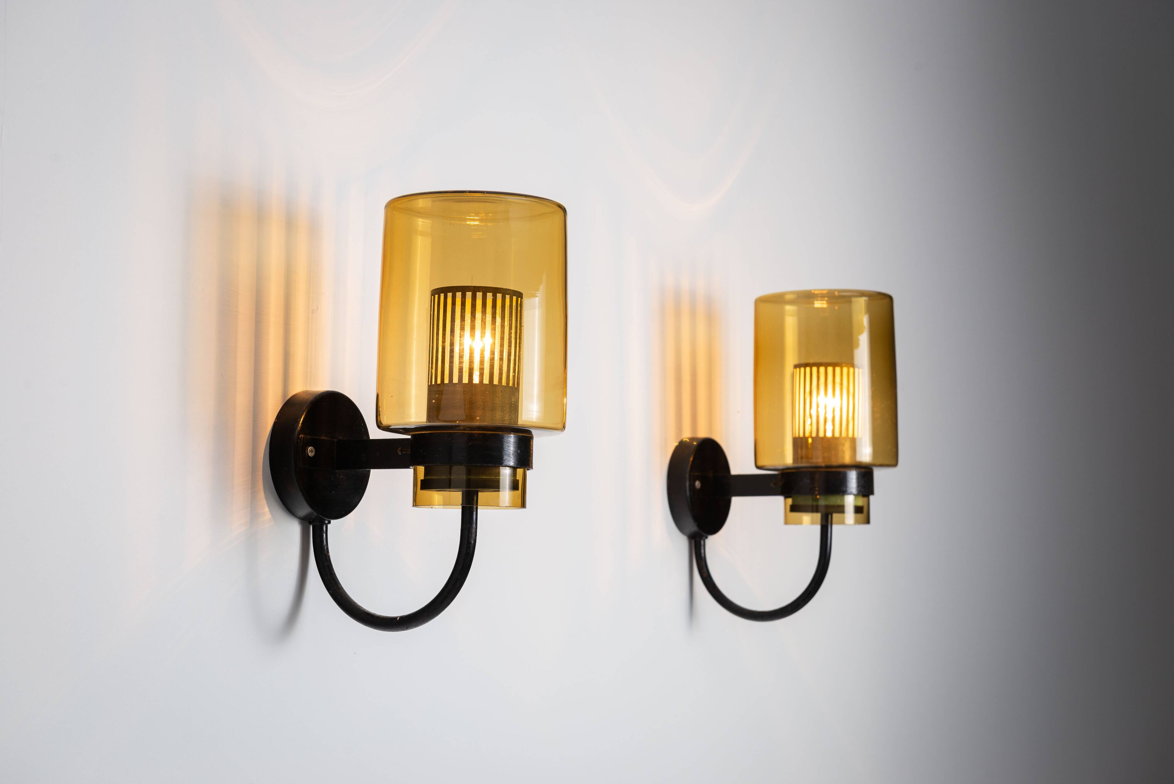 Pair of black metal wall lamps with yellow shades and inner diffuser