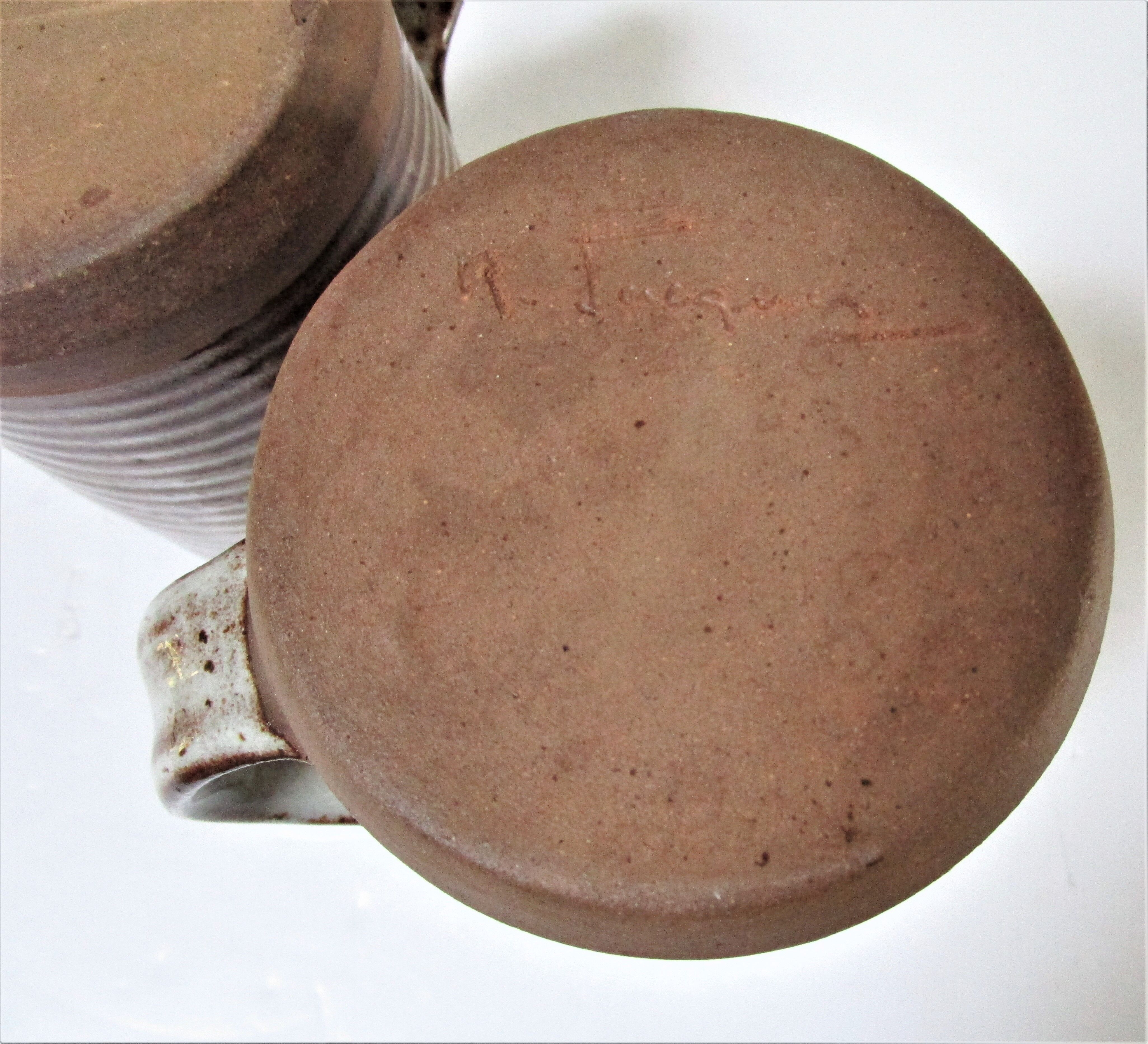 Two enamelled sandstone mugs Roger Jacques handwritten signature
