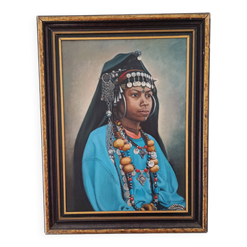 Portrait of a young Moroccan woman in traditional attire and adornments.