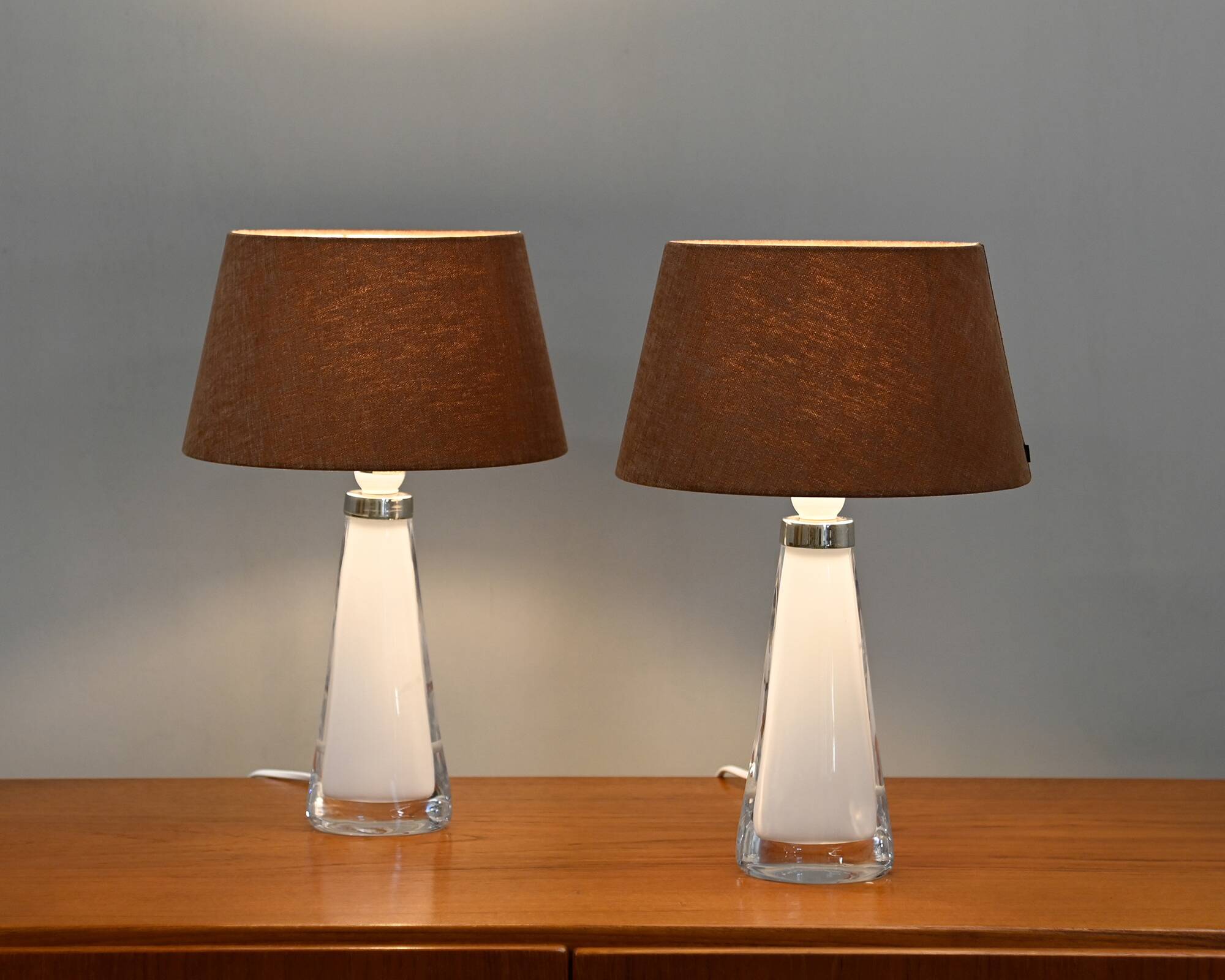 Carl Fagerlund white glass table lamps and dark ochre shades for Orrefors Sweden