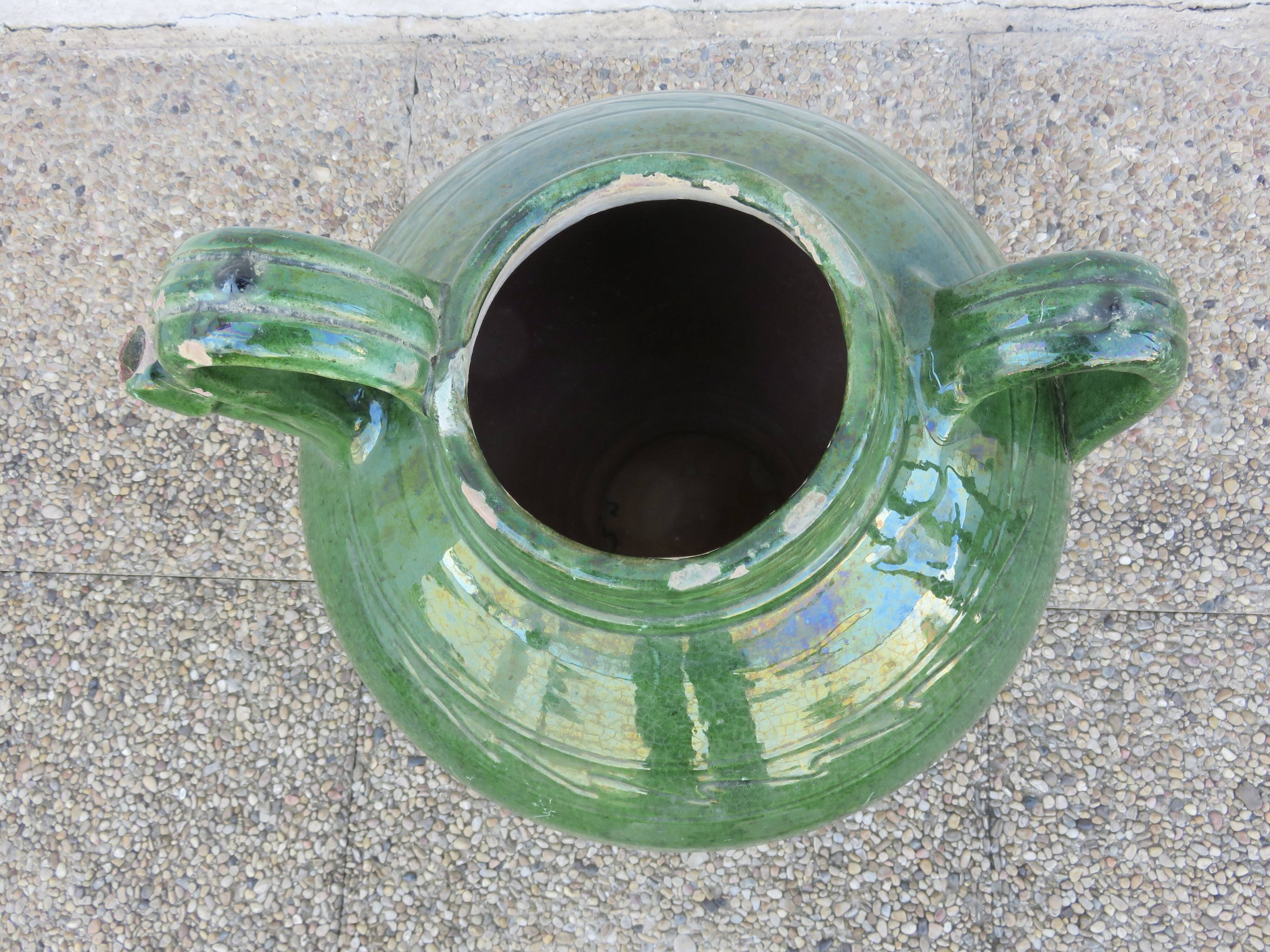 Antique glazed green terracotta oil jar, late 19th century.