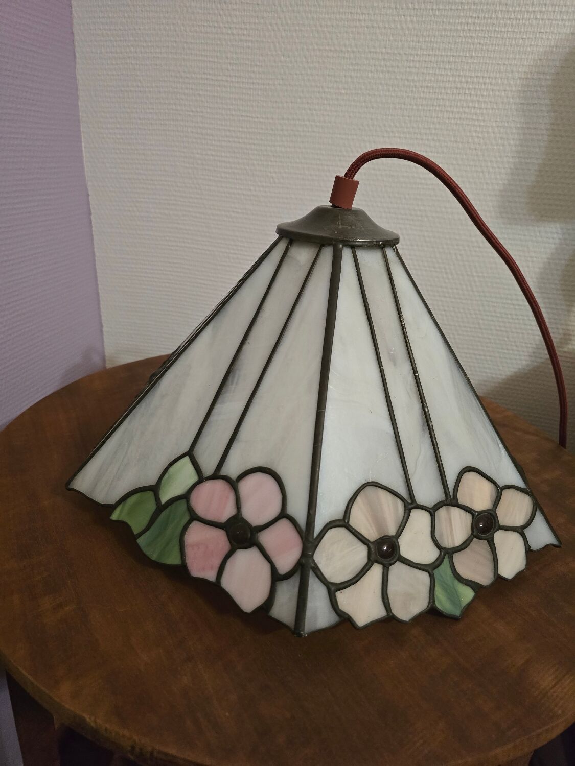 Tiffany-style stained glass lampshade with floral motifs.