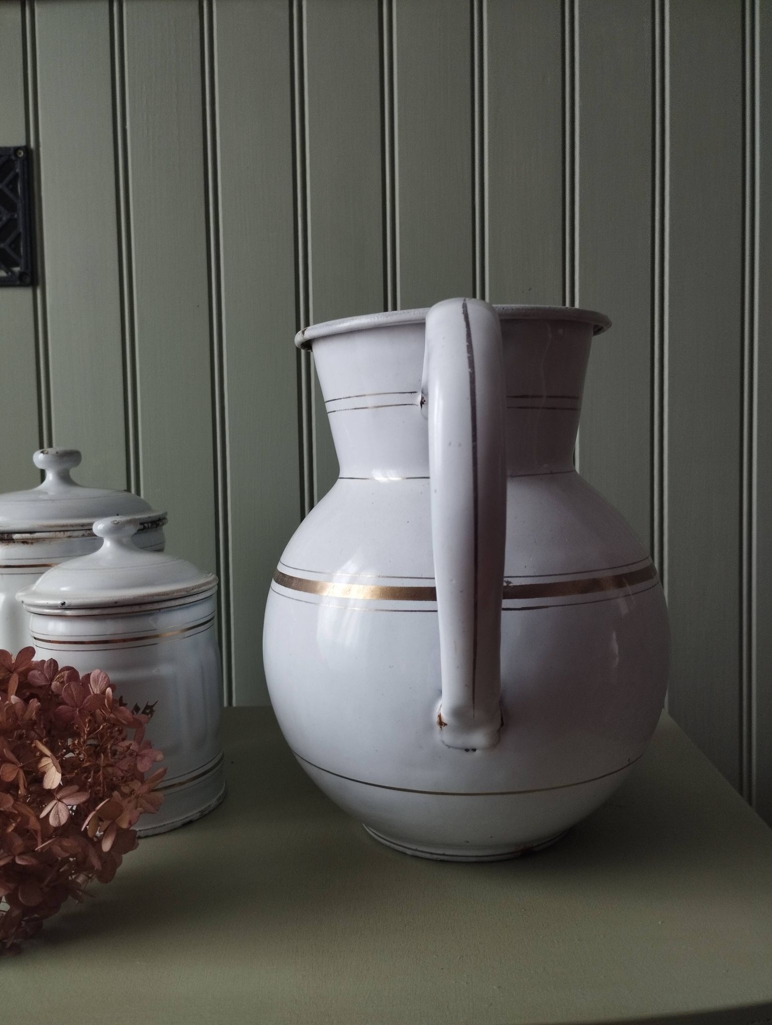 Rare large, pot-bellied toilet jug in white enamelled sheet metal with gold edging