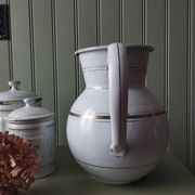 Rare large, pot-bellied toilet jug in white enamelled sheet metal with gold edging