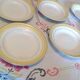 Six white hollow plates on board yellow Monaco 60