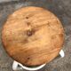 Vintage bar stool in white lace-up, round wooden seat rests circular feet