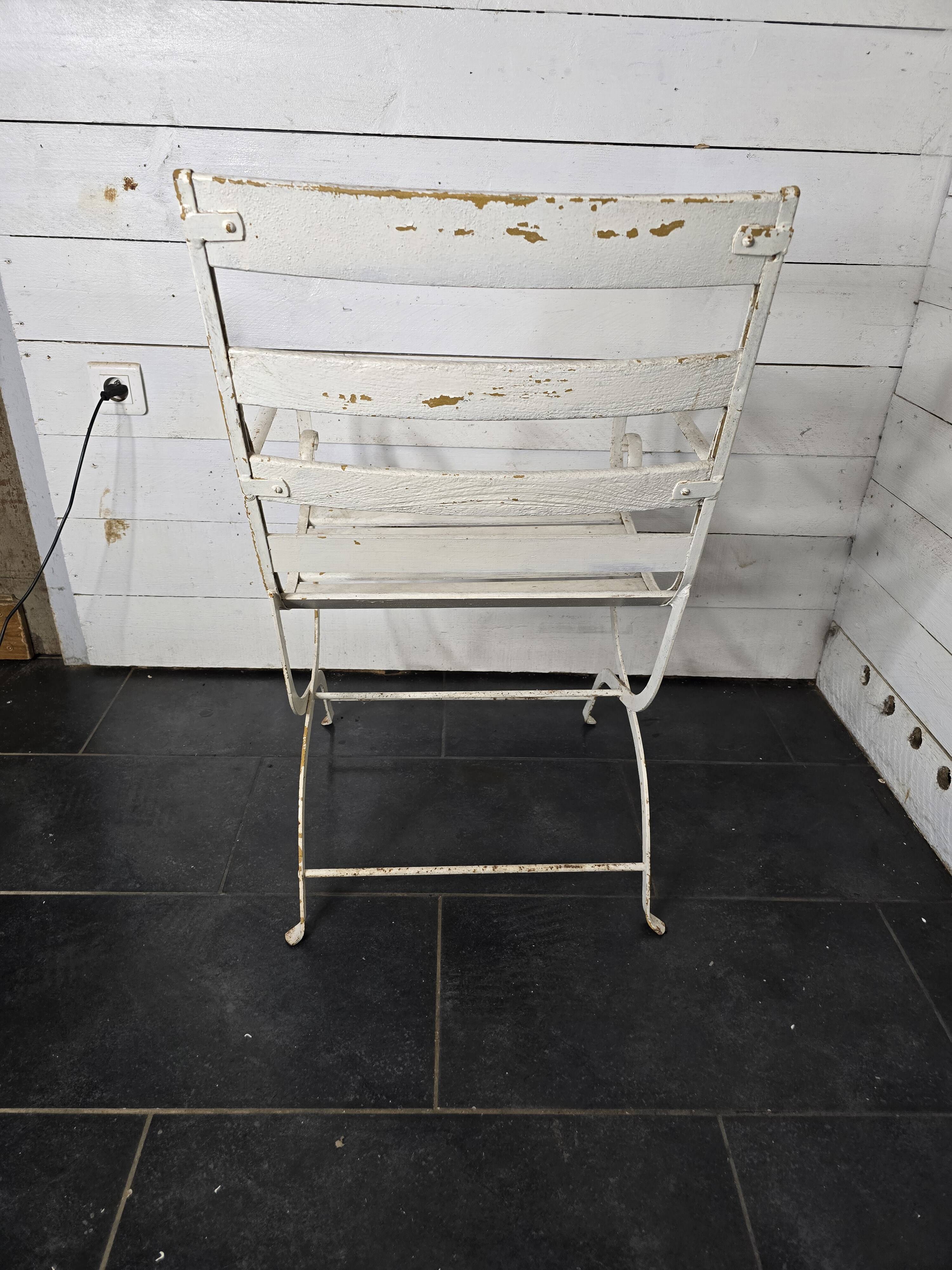 Old wrought iron and wood garden armchair