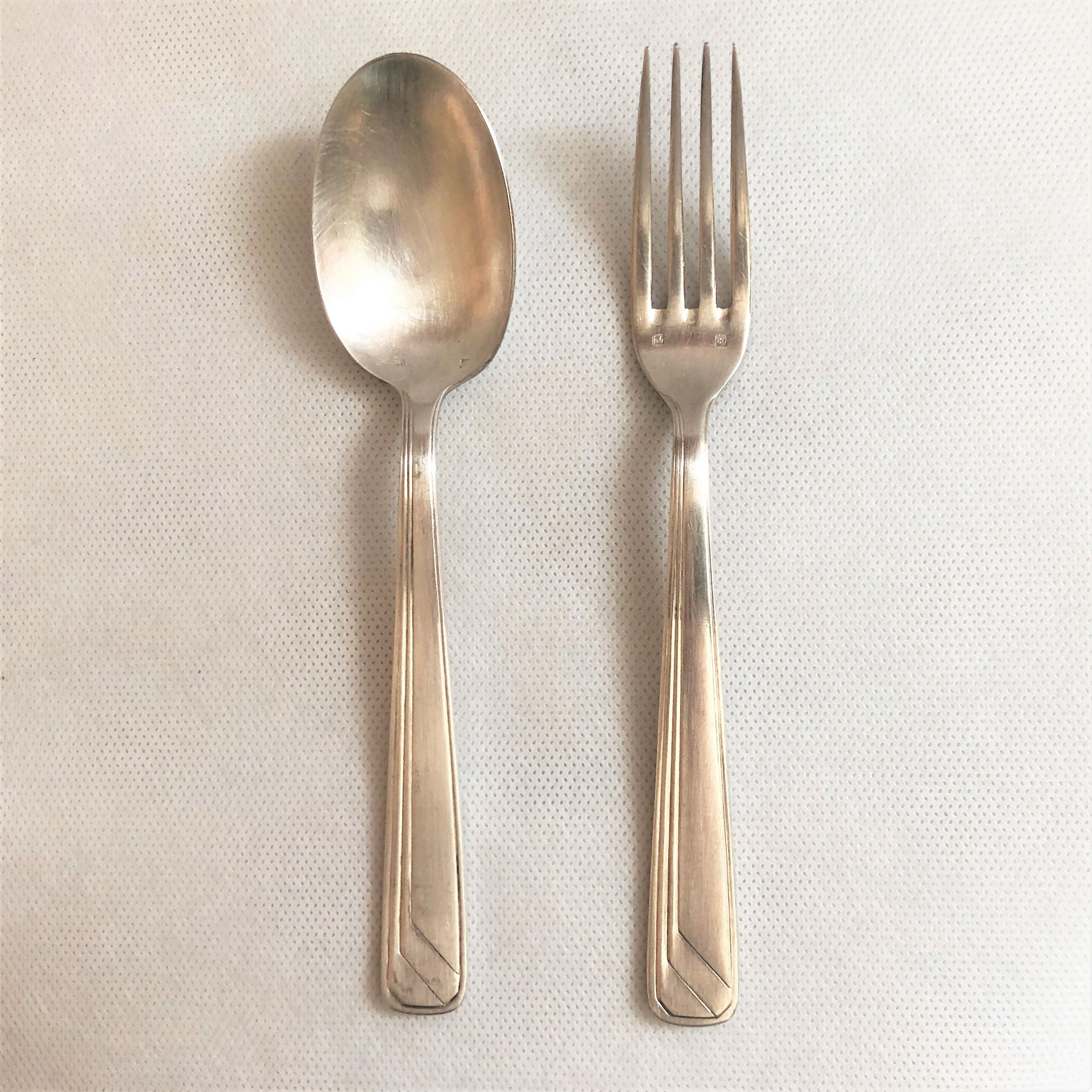 Set of 2 silver metal cutlery with punches