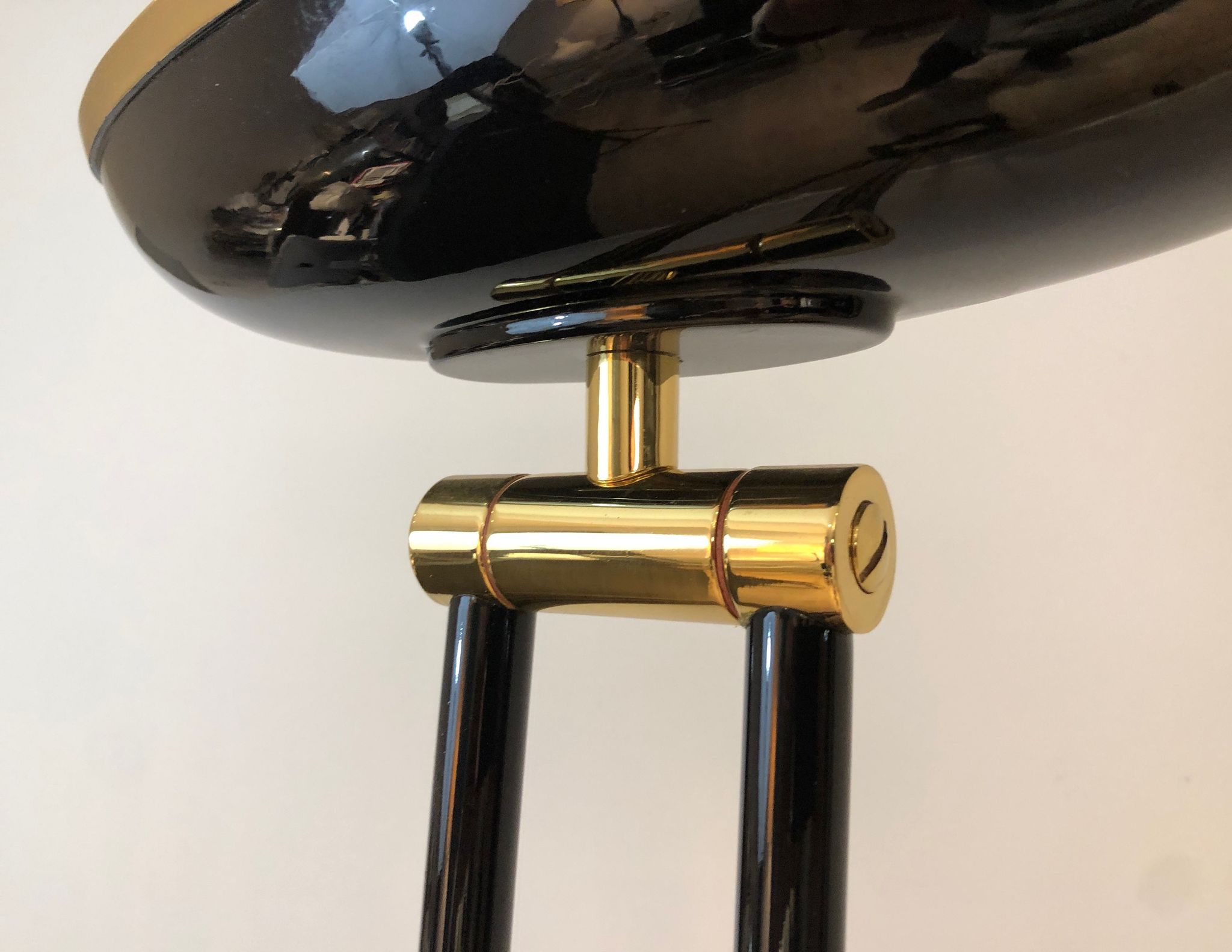 Black lacquered metal floor lamp with brass.