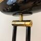 Black lacquered metal floor lamp with brass.