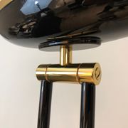 Black lacquered metal floor lamp with brass.