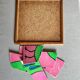 Wooden frame puzzle from the 1960s depicting a bird on a pink background.