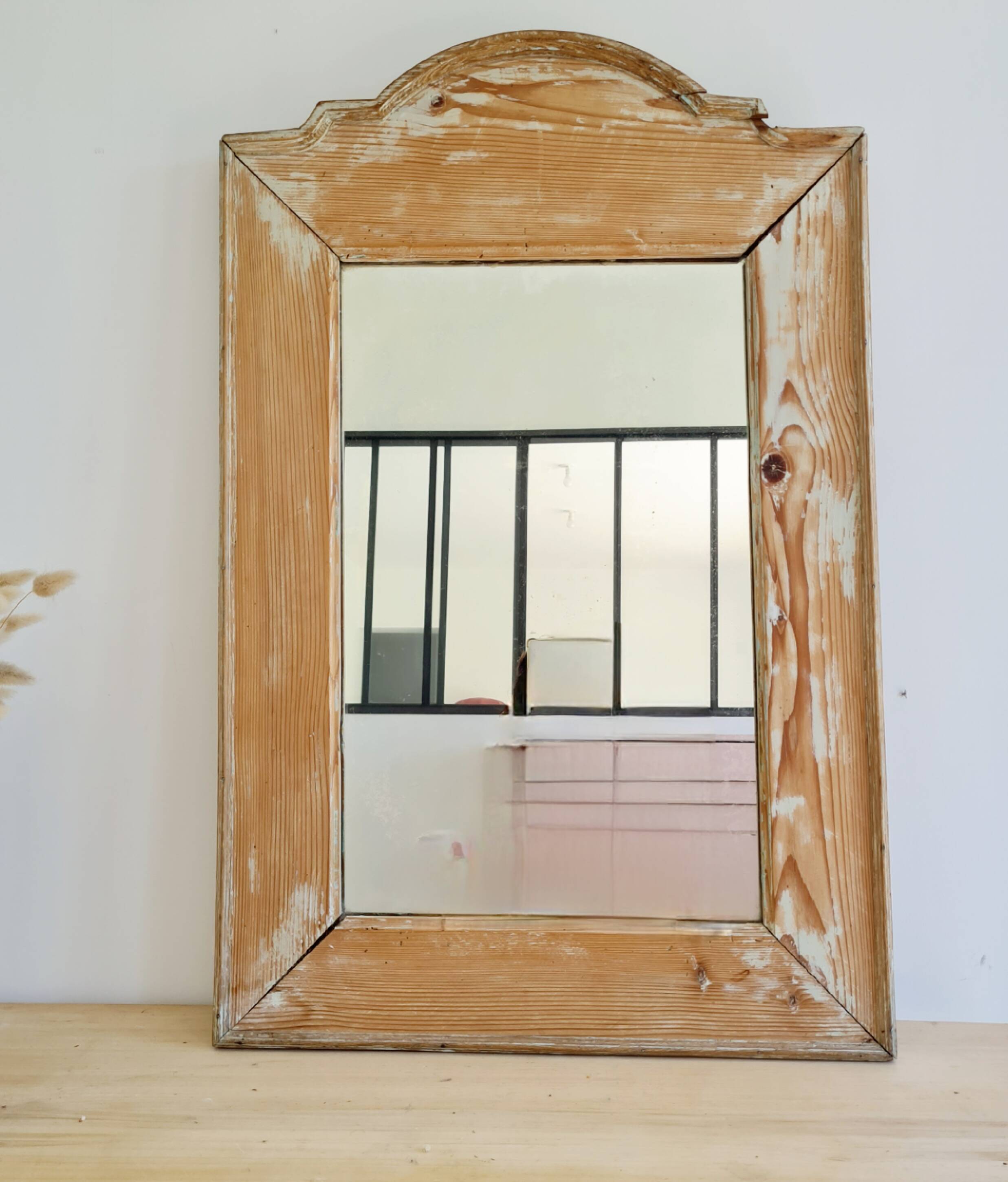 Antique mirror in raw wood with a patina and pediment.