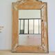 Antique mirror in raw wood with a patina and pediment.