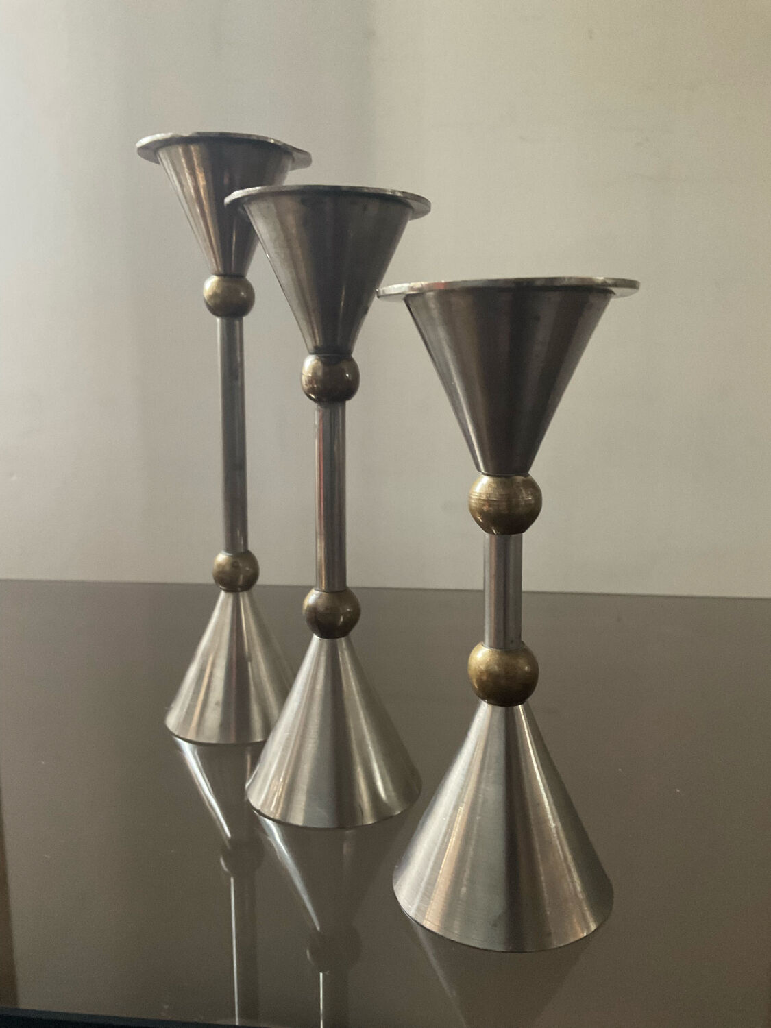 Trio of vintage metal and bronze candle holders