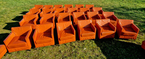 Pair of vintage orange leather armchairs