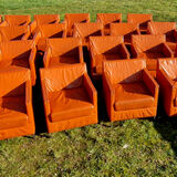 Pair of vintage orange leather armchairs