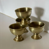 4 golden brass egg cups