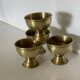 4 golden brass egg cups