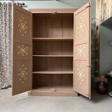 Large antique wardrobe painted with floral decoration.