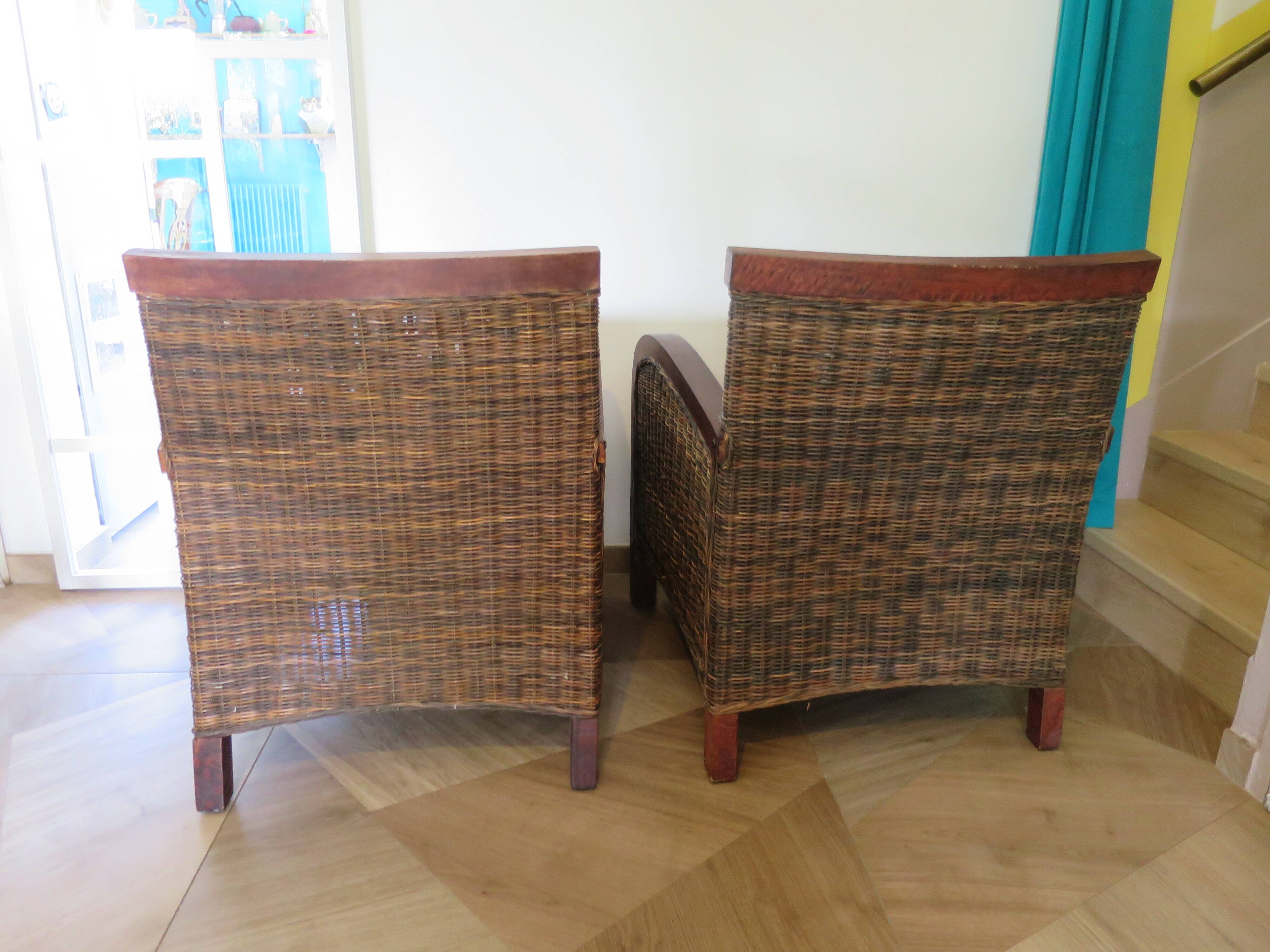 2 colonial-style armchairs in woven rattan and exotic wood
